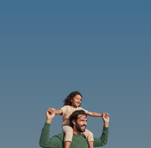 A father carrying his daughter on his shoulders